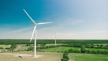 An image of wind turbines in a filed